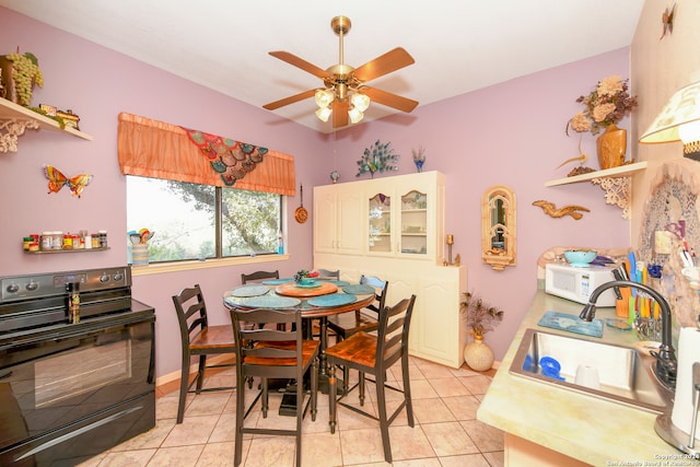 dining room with light tile patterned flooring, sink, and ceiling fan