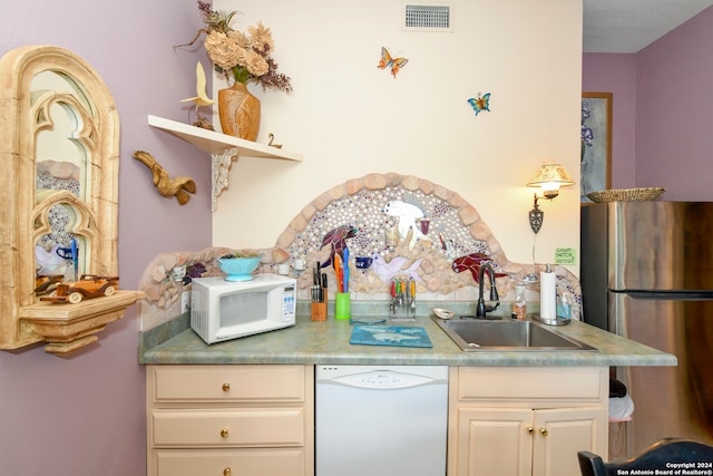 kitchen featuring sink and white appliances