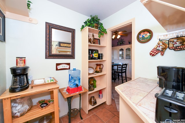 interior space with tile patterned floors and ceiling fan