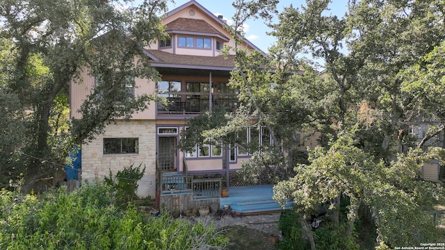 rear view of house featuring a balcony