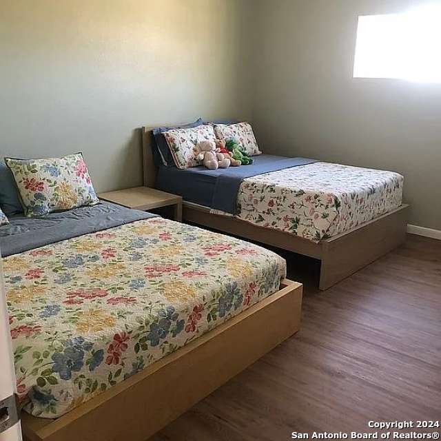 bedroom with hardwood / wood-style flooring