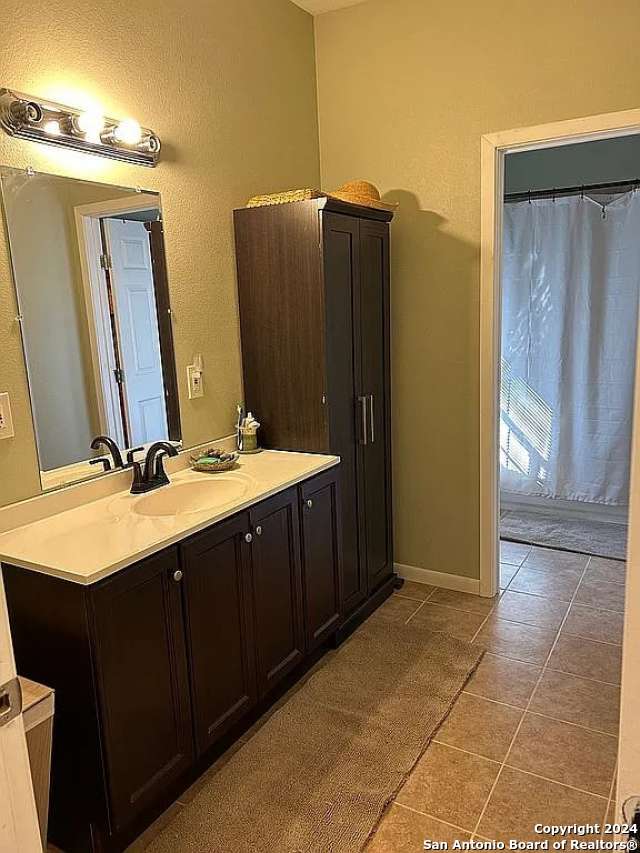 bathroom with vanity and tile patterned floors