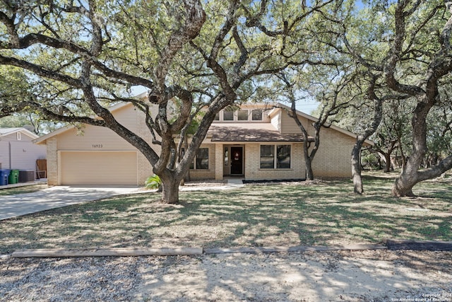 view of front of property featuring a garage and a front lawn