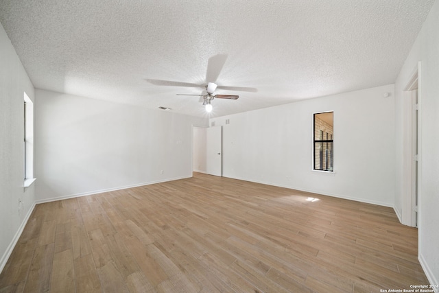 spare room featuring a textured ceiling, ceiling fan, and light hardwood / wood-style flooring