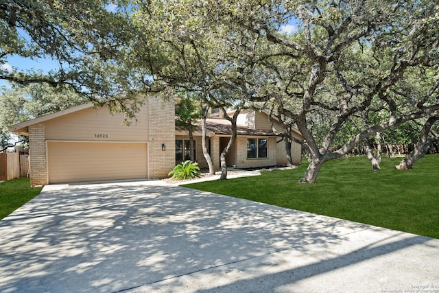 view of front of property with a garage and a front lawn