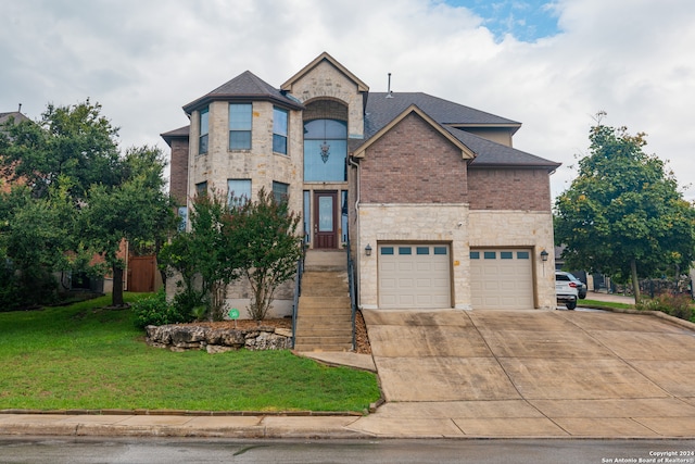 view of front of house with a garage and a front lawn