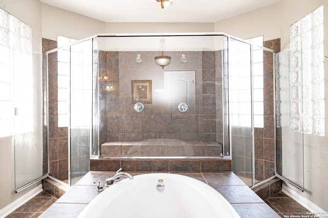 bathroom with tile patterned floors and independent shower and bath