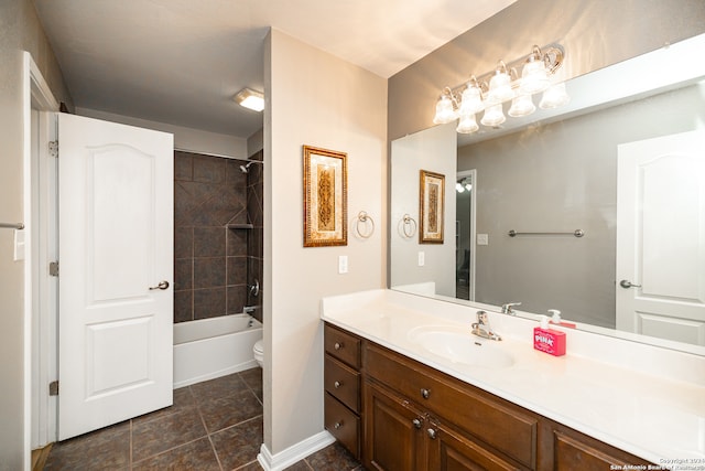 full bathroom featuring vanity, tile patterned flooring, toilet, and tiled shower / bath