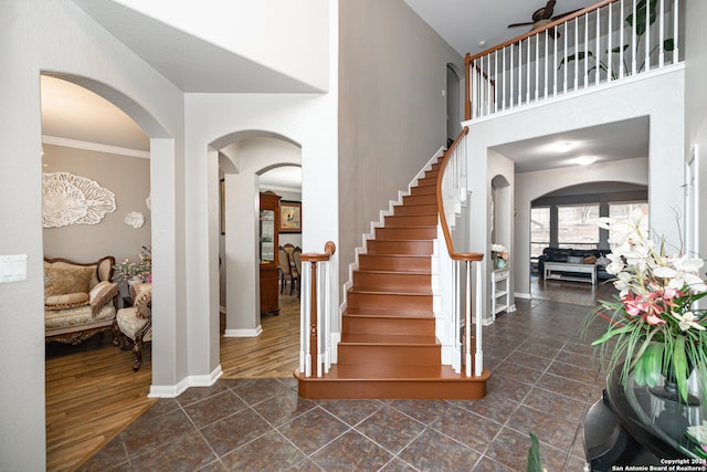 entryway with ornamental molding, ceiling fan, and dark hardwood / wood-style floors