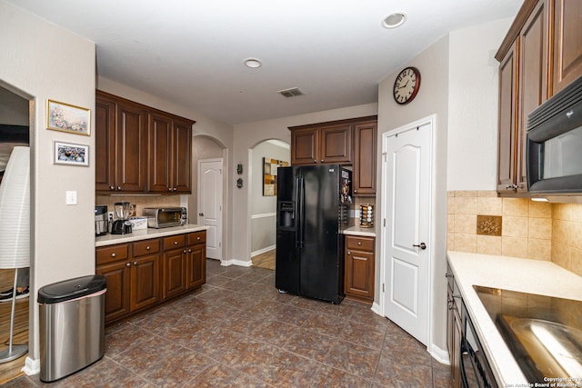 kitchen featuring decorative backsplash and black appliances