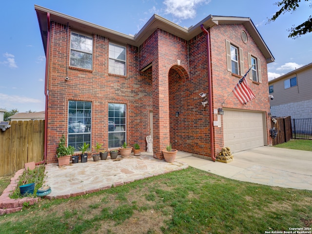 view of front facade with a garage and a front lawn