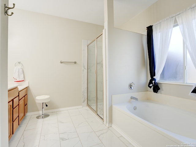 bathroom with vanity, separate shower and tub, and a wealth of natural light