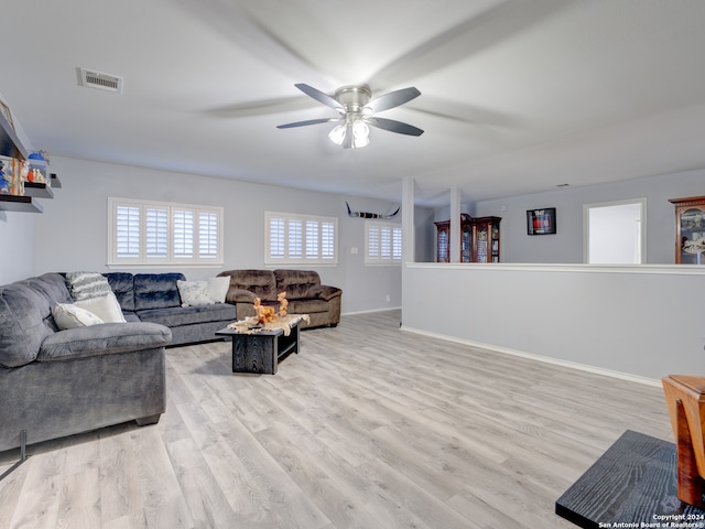 living room featuring light wood-type flooring and ceiling fan