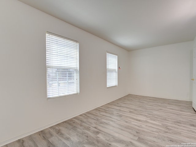 unfurnished room with light hardwood / wood-style flooring