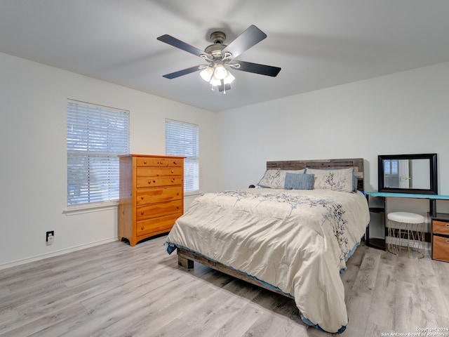 bedroom with ceiling fan and light wood-type flooring