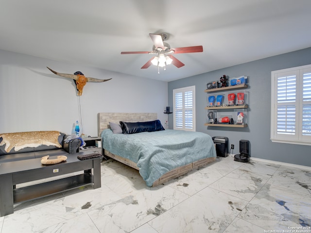 bedroom with multiple windows and ceiling fan