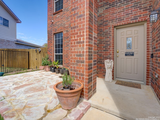 entrance to property featuring a patio