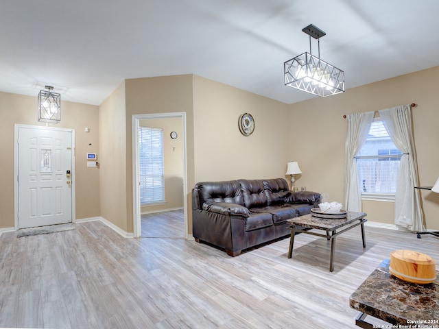 living room featuring light hardwood / wood-style floors and an inviting chandelier