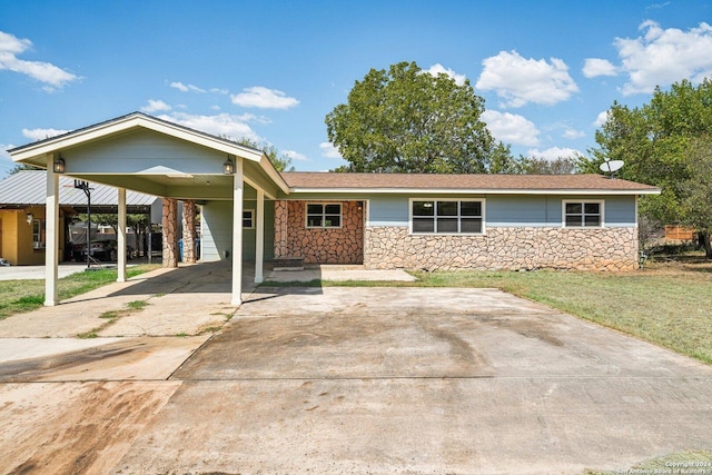 1505 B St, Floresville, TX 78114 - view of front facade featuring stone siding, a carport, a front yard, and concrete driveway