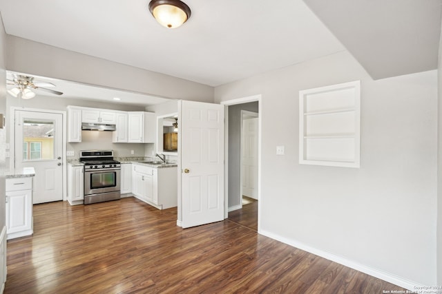 kitchen featuring stainless steel range with gas cooktop, dark hardwood / wood-style floors, sink, and white cabinets