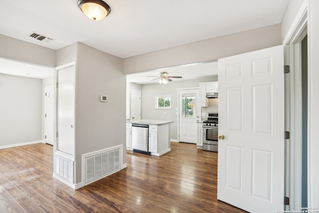 kitchen with ceiling fan, stainless steel appliances, dark hardwood / wood-style floors, and white cabinets