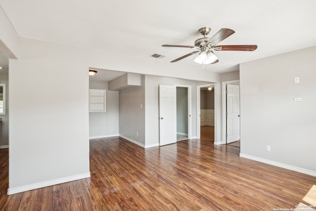 empty room featuring ceiling fan and dark hardwood / wood-style flooring