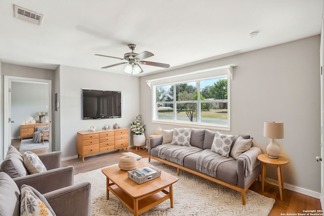 1505 B St, Floresville, TX 78114 - living area with light wood-style floors, ceiling fan, and baseboards