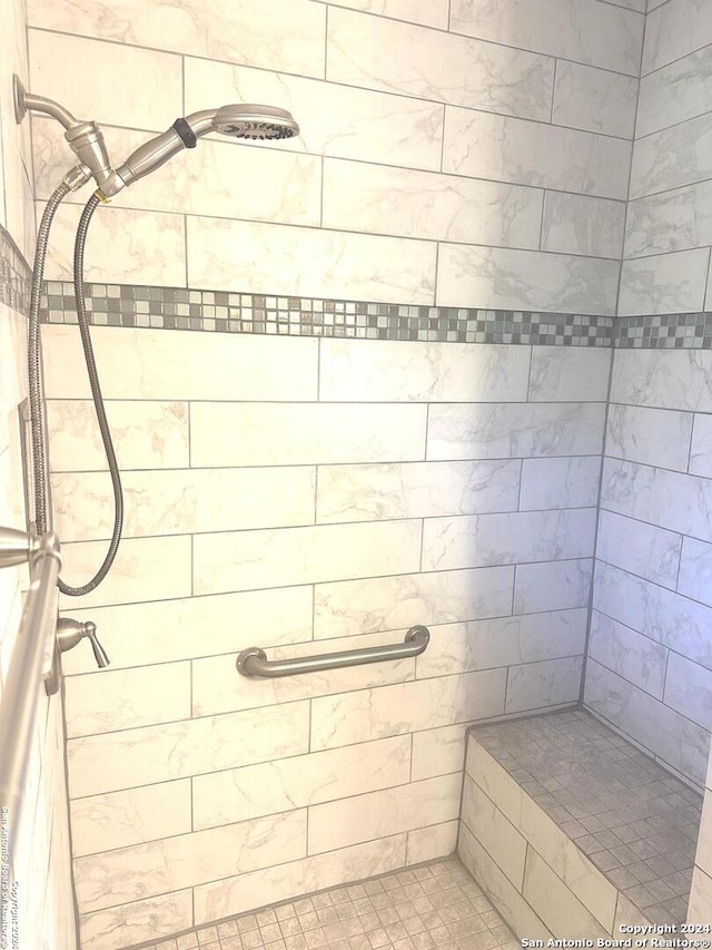 bathroom with a tile shower