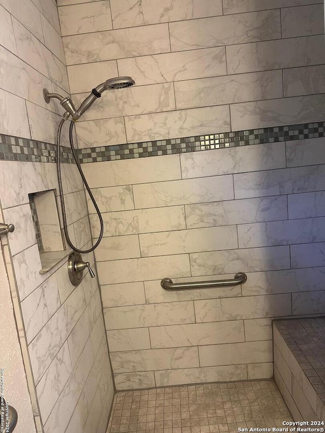 bathroom with a tile shower