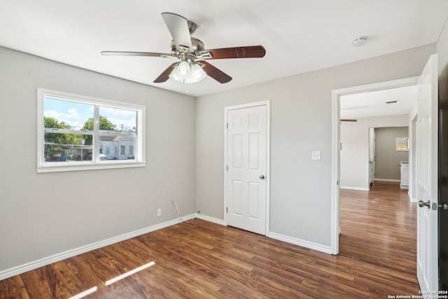 unfurnished bedroom with dark hardwood / wood-style floors and ceiling fan