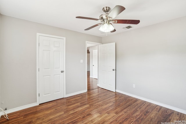 unfurnished bedroom with dark wood-type flooring and ceiling fan