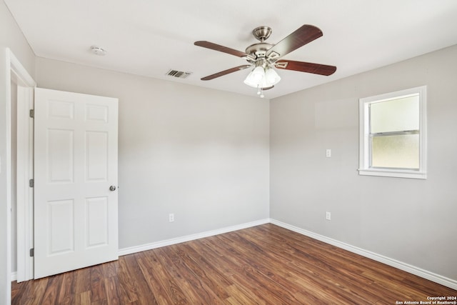 spare room featuring ceiling fan and dark hardwood / wood-style floors