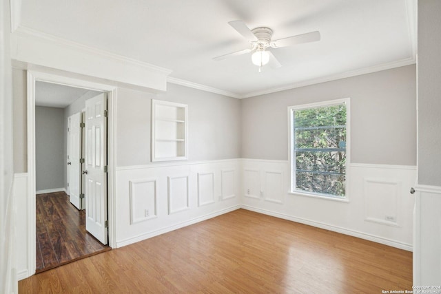 1505 B St, Floresville, TX 78114 - unfurnished room featuring wood finished floors, wainscoting, a ceiling fan, and ornamental molding