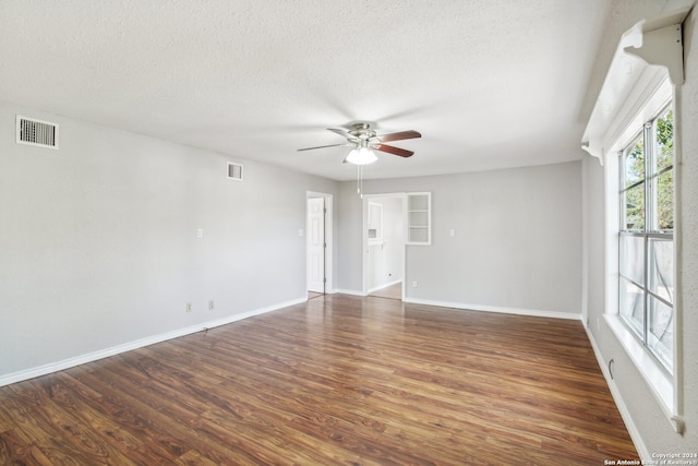 spare room with ceiling fan, dark hardwood / wood-style flooring, and a textured ceiling