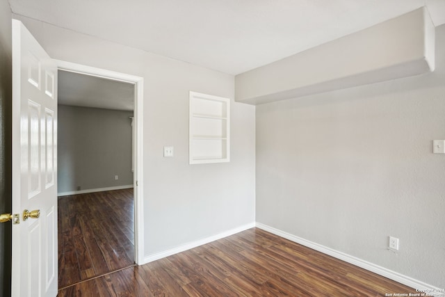 empty room with dark wood-type flooring