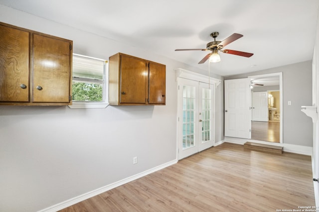 unfurnished room featuring french doors, ceiling fan, and light hardwood / wood-style flooring