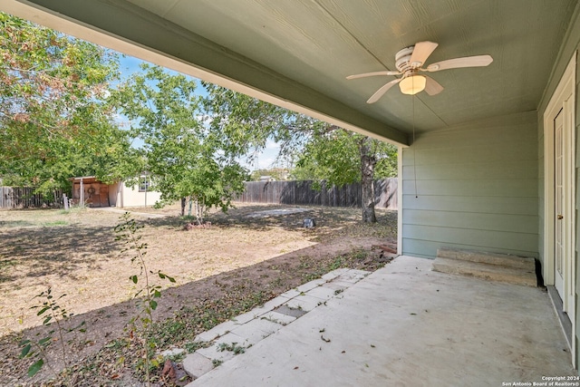 view of patio featuring ceiling fan and a storage shed