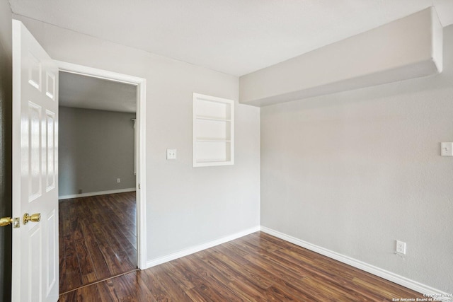 1505 B St, Floresville, TX 78114 - empty room featuring dark wood-type flooring and baseboards