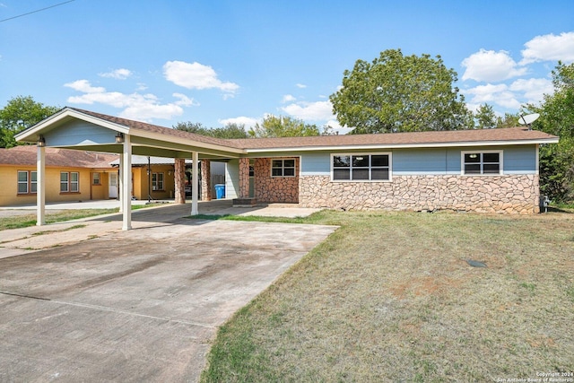 1505 B St, Floresville, TX 78114 - view of front of property featuring stone siding, a front lawn, and an attached carport