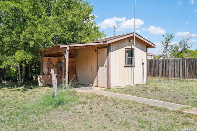 view of outbuilding with a yard