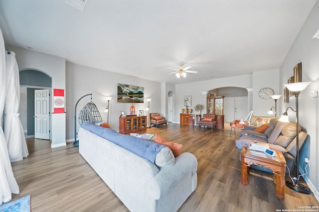 living room with wood-type flooring and ceiling fan