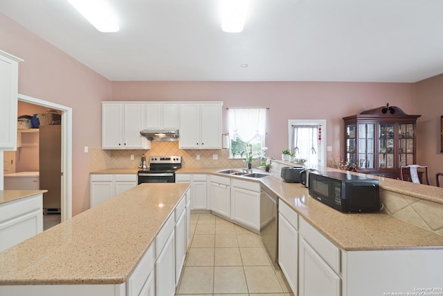 kitchen featuring appliances with stainless steel finishes, light tile patterned flooring, white cabinetry, a kitchen island, and sink