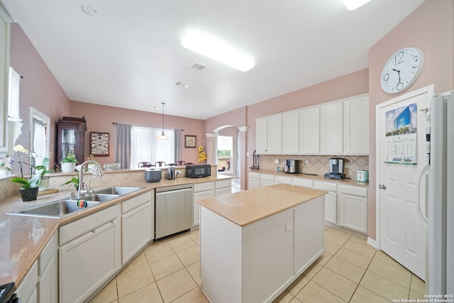 kitchen featuring white refrigerator, decorative light fixtures, white cabinetry, and stainless steel dishwasher