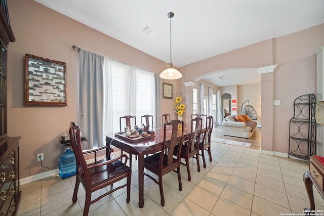 dining area with light tile patterned flooring and ornate columns