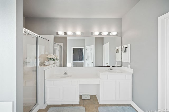 bathroom with tile patterned flooring, a shower with door, and vanity