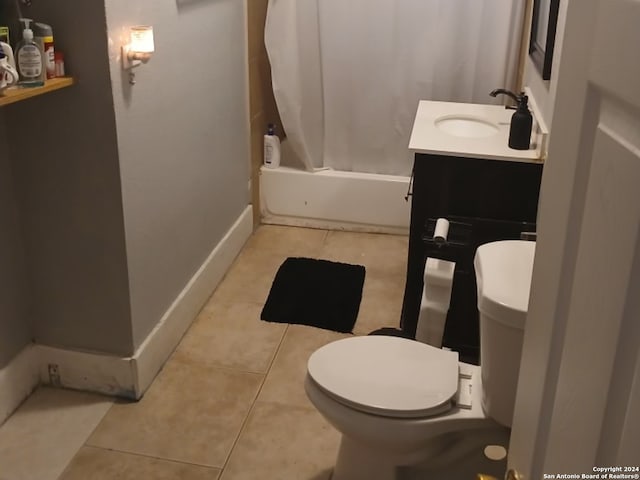 full bathroom with tile patterned flooring, shower / tub combo, vanity, and toilet