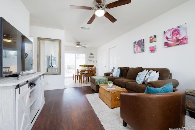 living room with ceiling fan and dark hardwood / wood-style floors