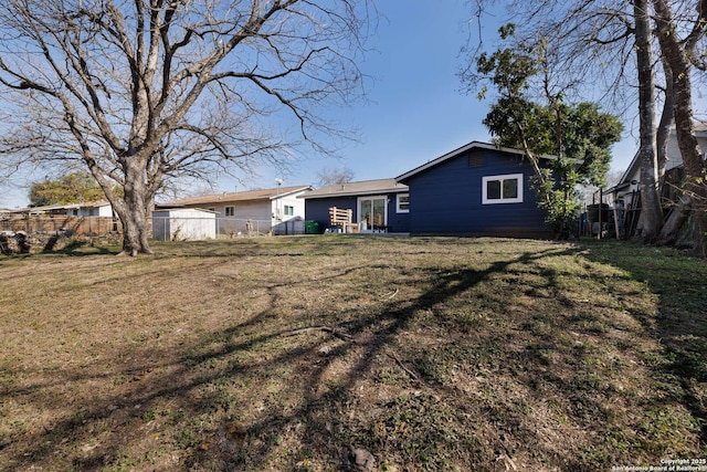 rear view of property with a yard