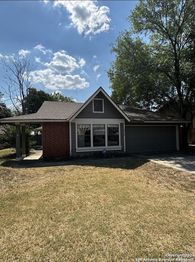 ranch-style house featuring a front lawn and a garage