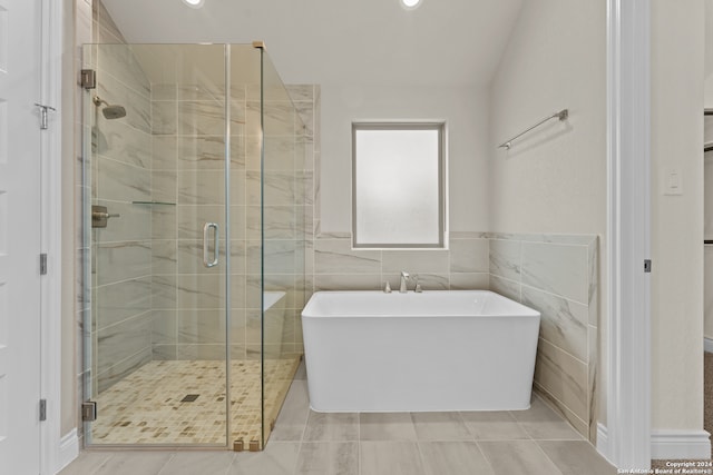 bathroom featuring tile patterned flooring, tile walls, and shower with separate bathtub